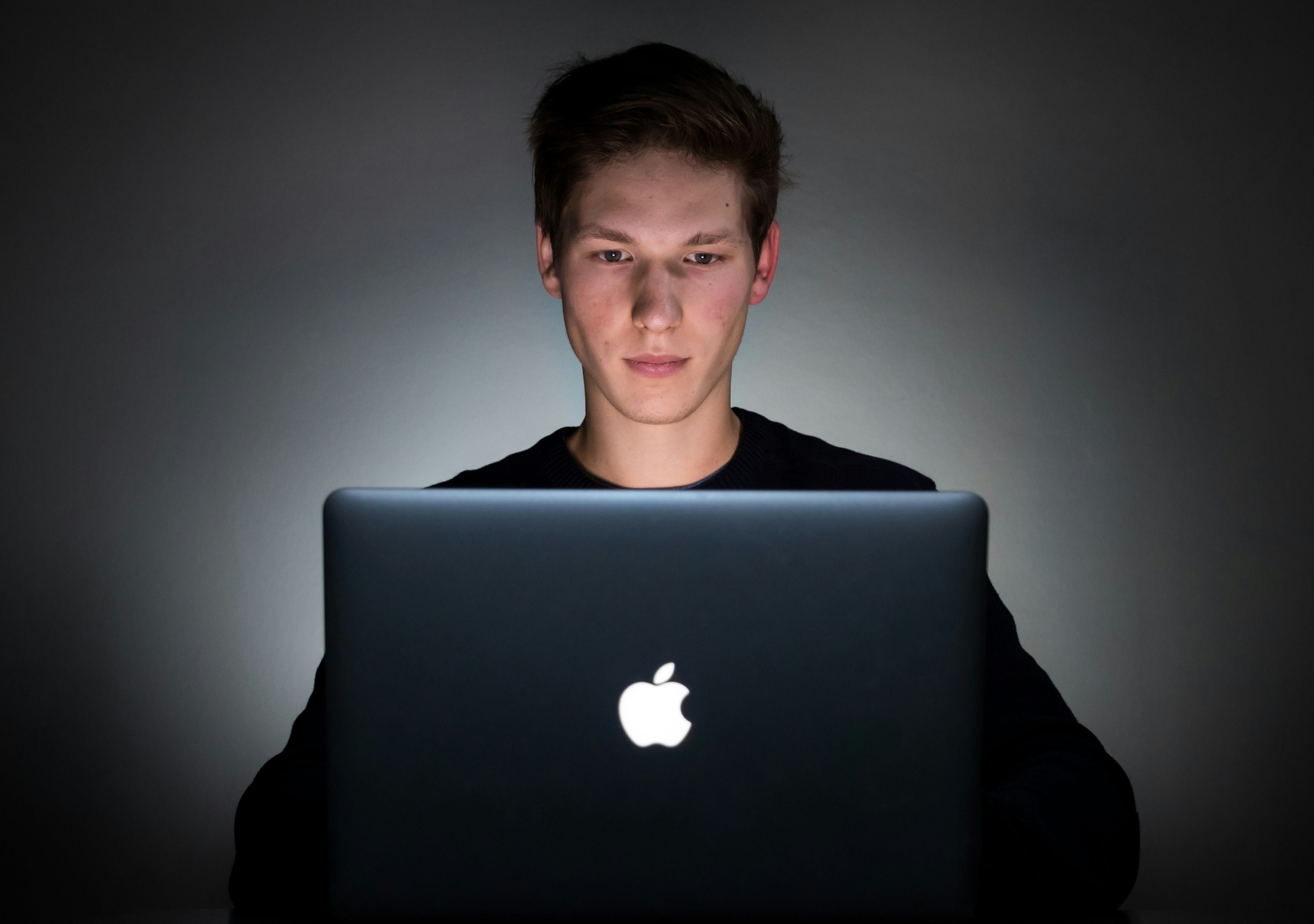student sitting and working on laptop -  Formative Assessment Using Technology