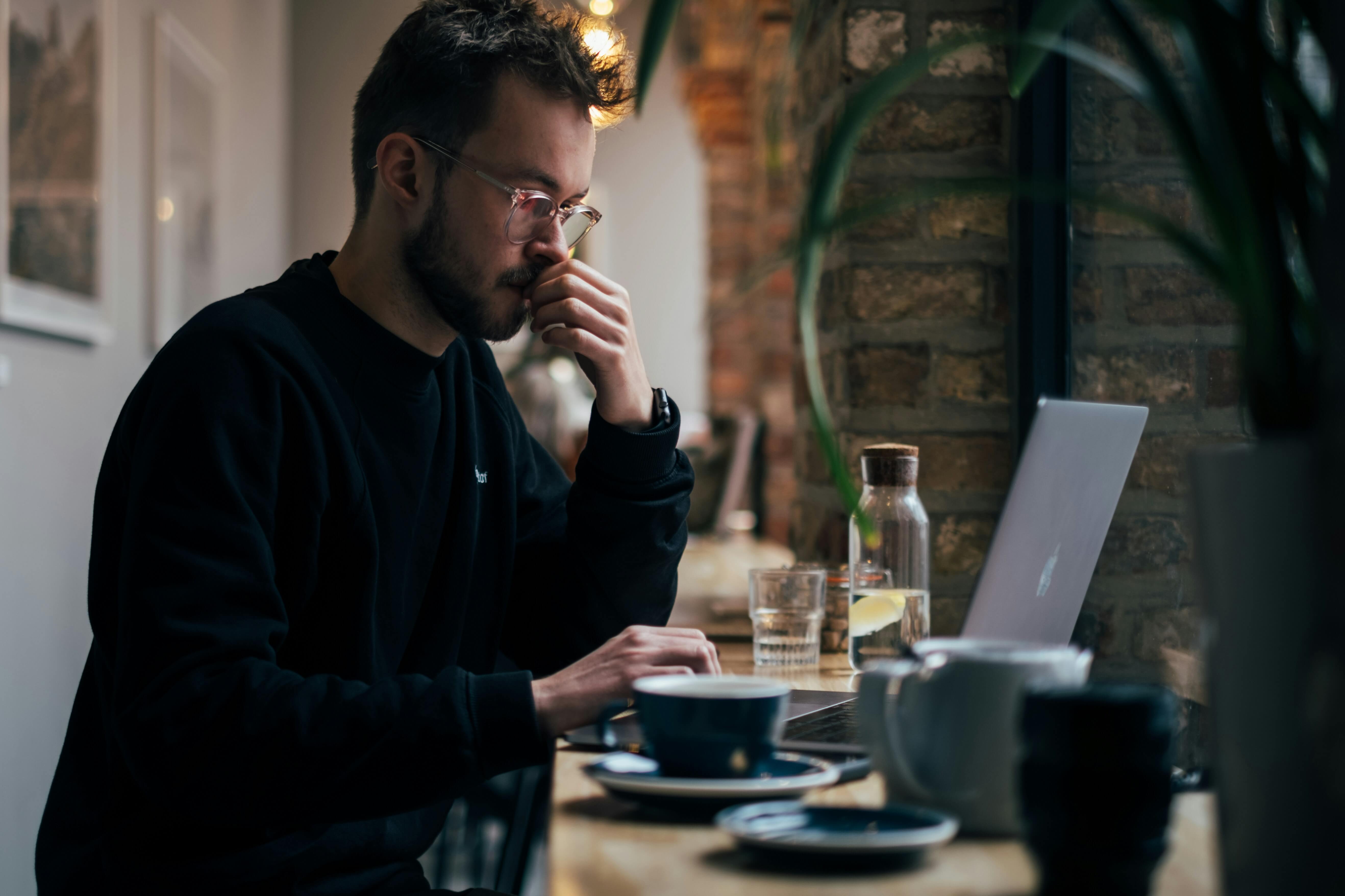 man working on laptop - AI in Assessment