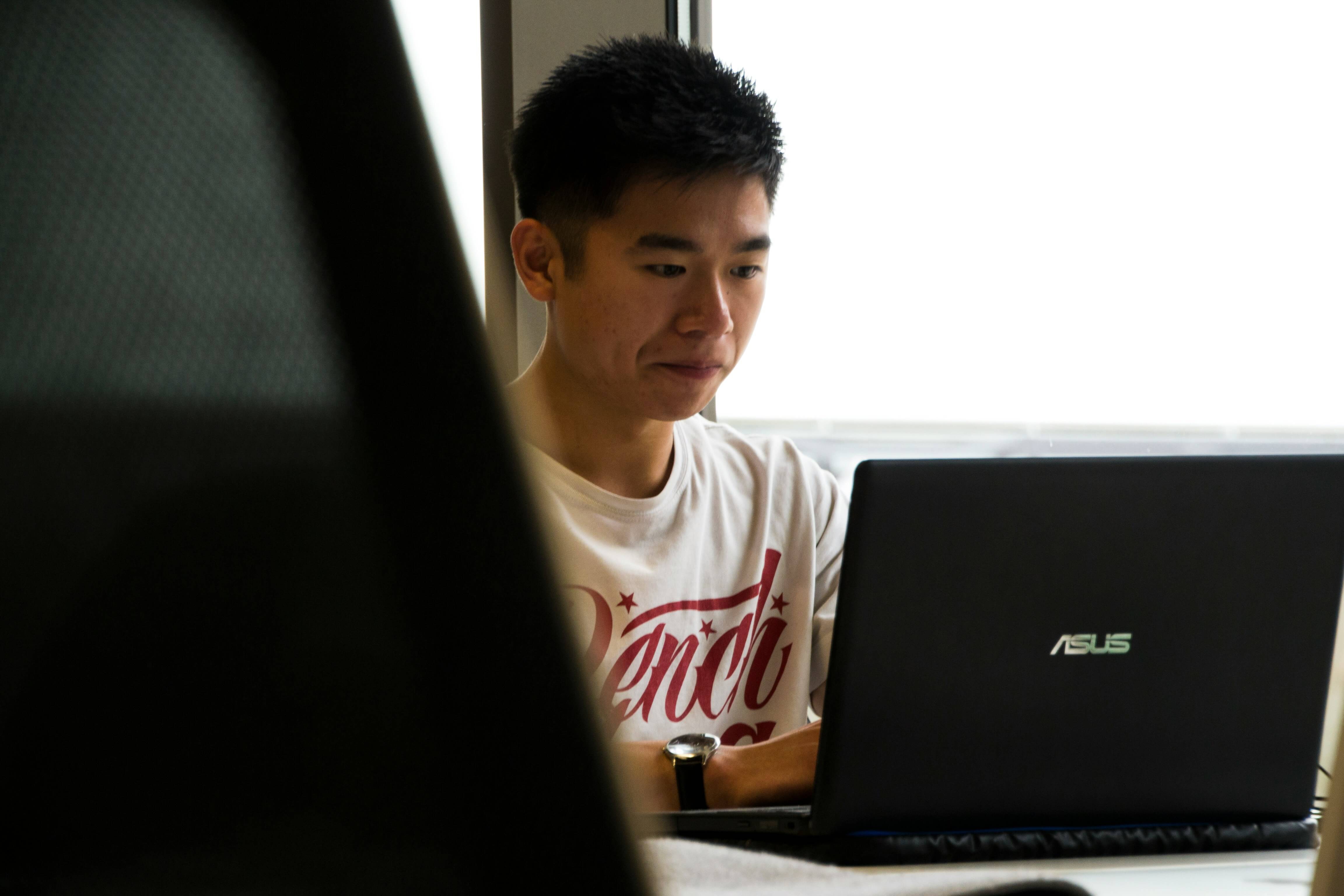 man working on laptop - AI Assessment Tools