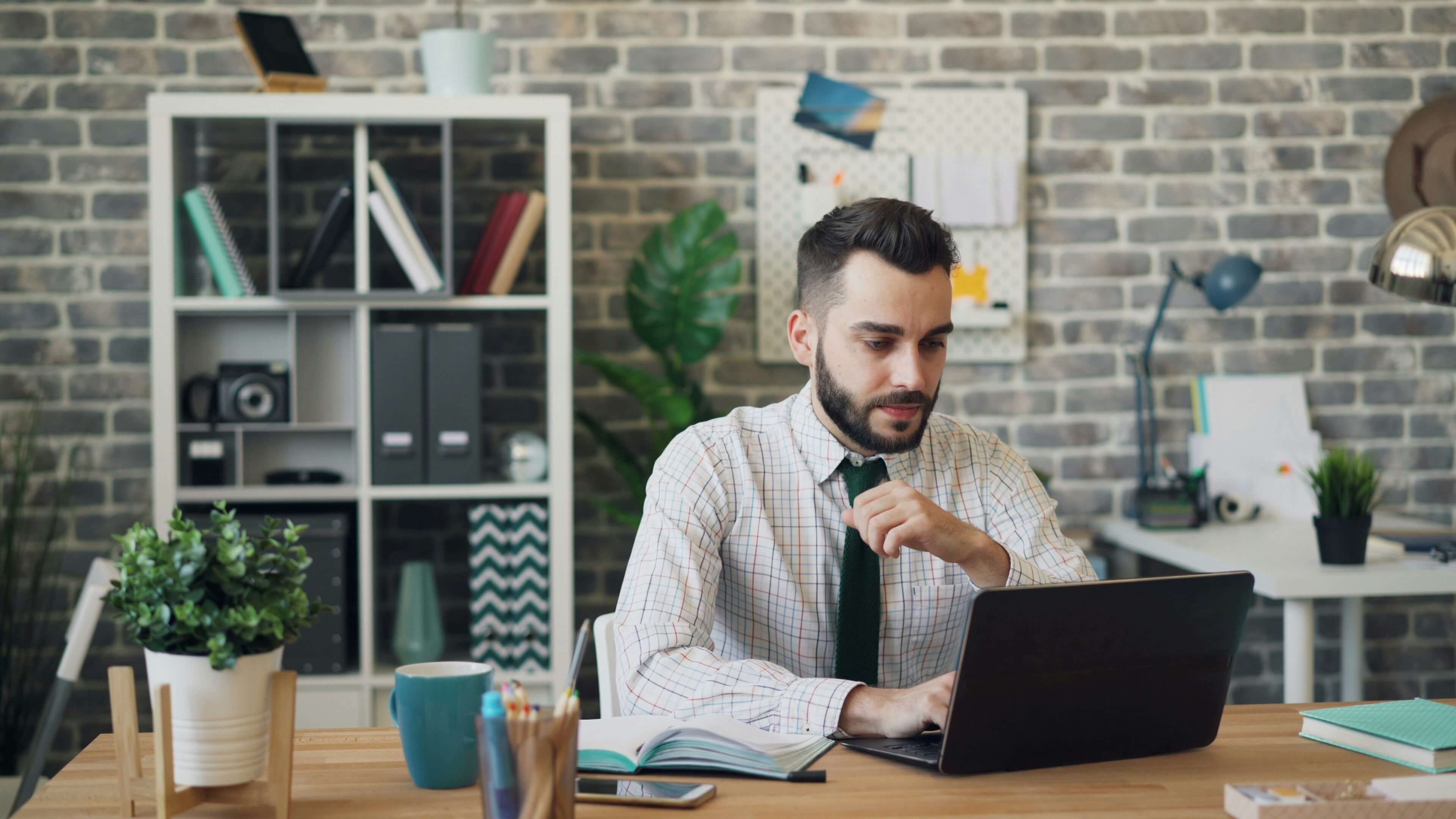 man working on a laptop - Assessment Apps for Teachers