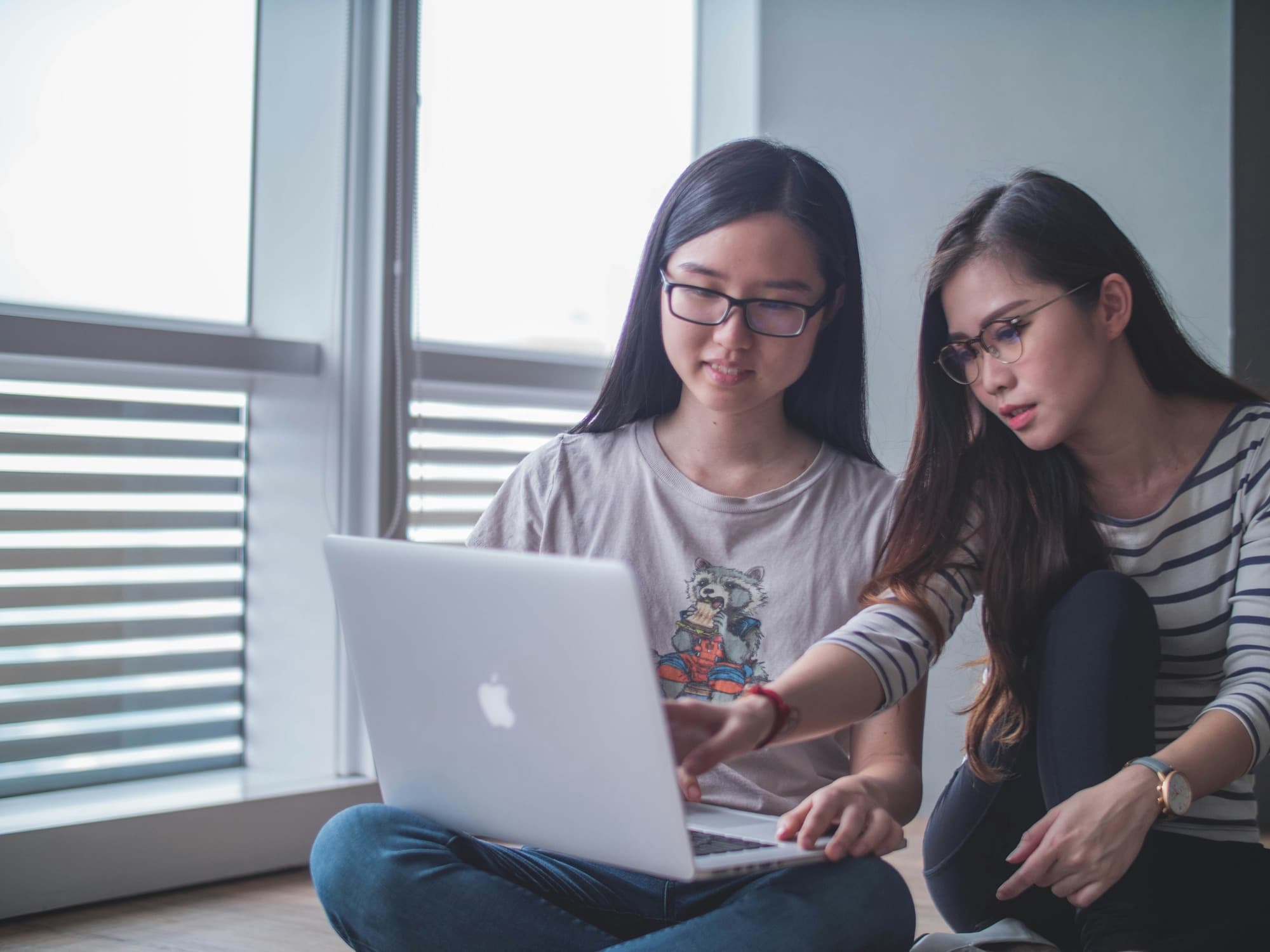 two girls working on a laptop - Types of Feedback for Students
