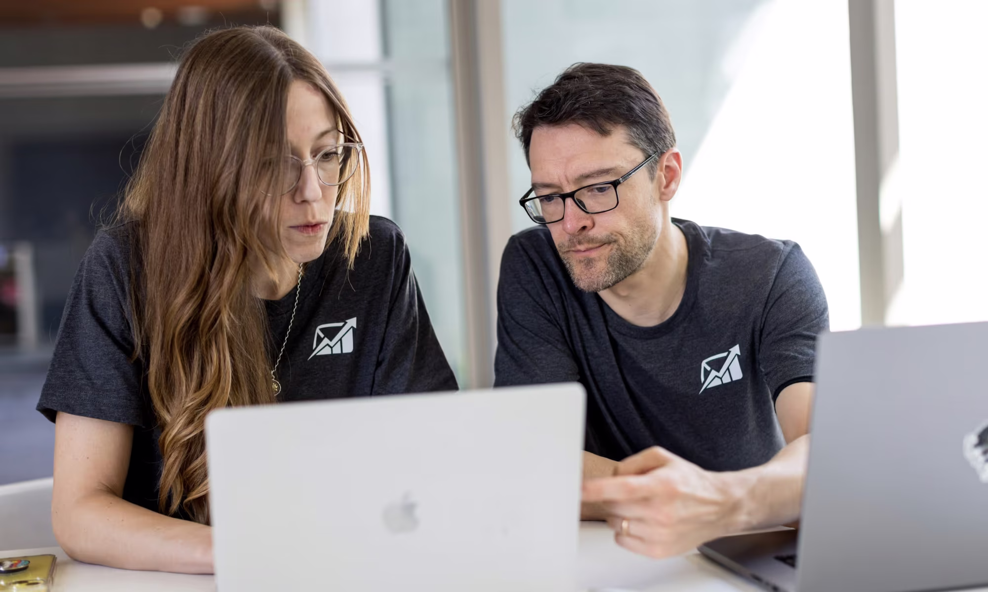 man and woman on a laptop - What Are Some Considerations Before Using AI in the Classroom?
