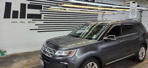 Car being worked on and getting hail damage repaired by our experts