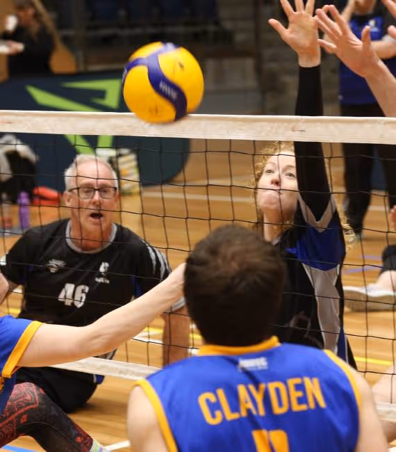 A game of sitting volleyball being played.