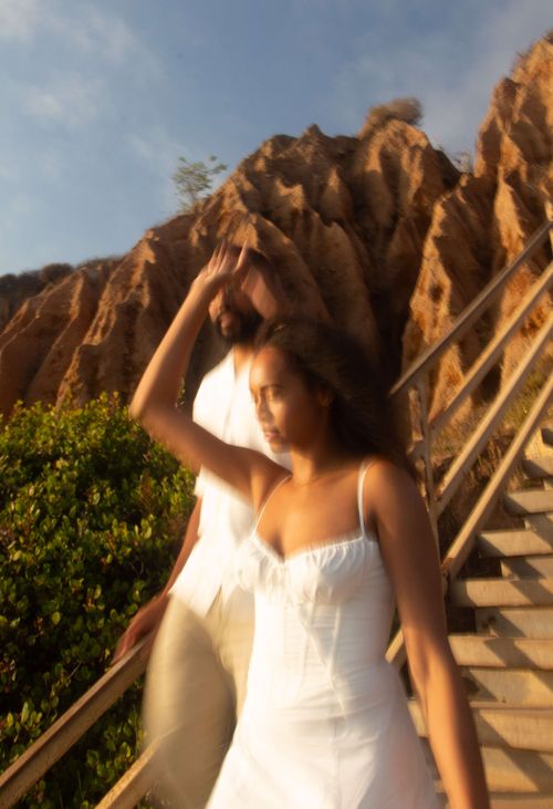 a blurry photo of the future bride and groom walking down stairs
