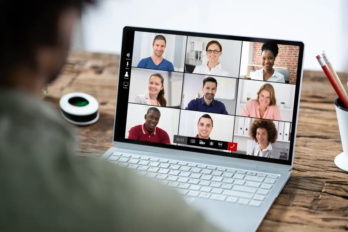 Person participating in an online coaching training session from a home office