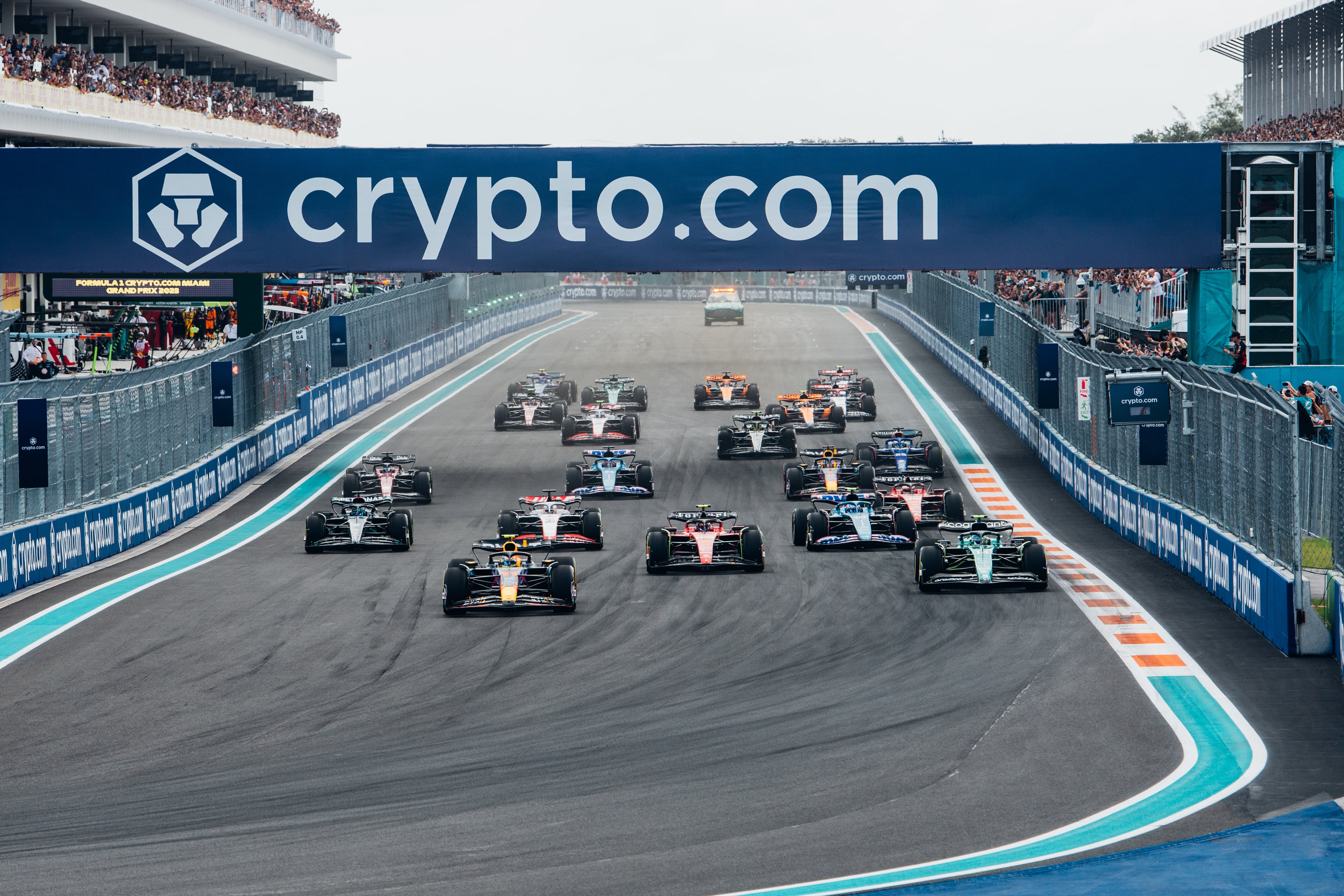 Formula 1 cars racing at Hard Rock Stadium with luxury Miami car service for fans