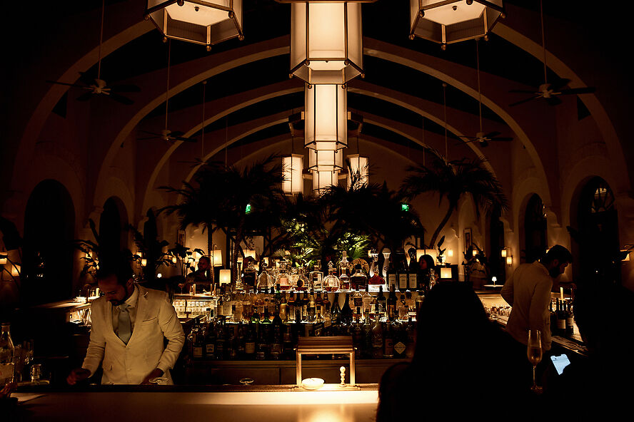 Guests enjoying the Four Seasons Surf Club bar arriving via private car service in Miami”