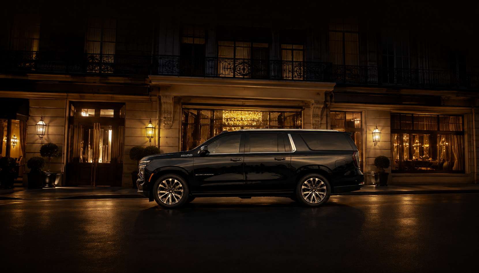 Black Chevrolet Suburban providing black car service in Miami by Miami Choice Limo, parked outside a luxury hotel at night.