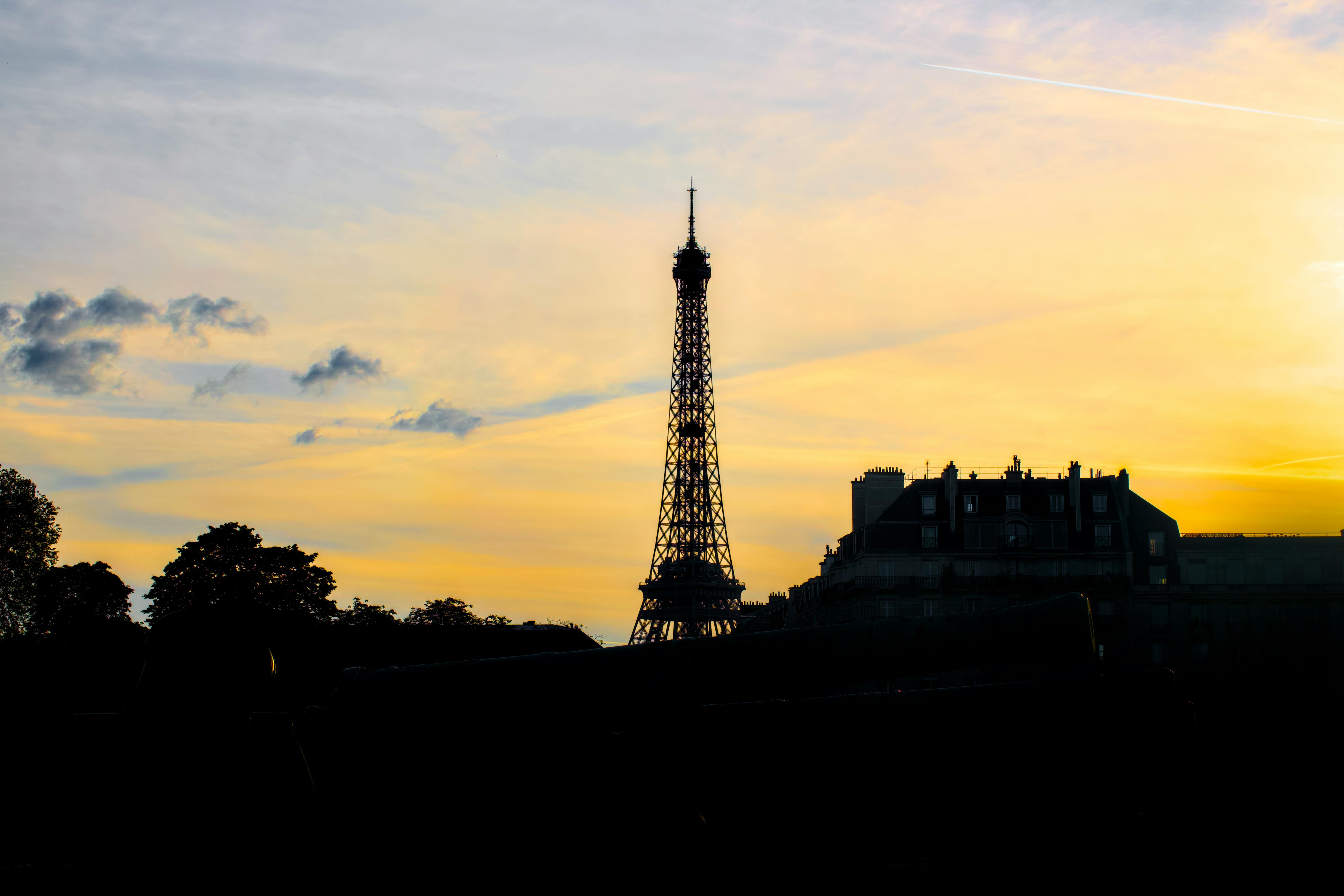 Eiffel Tower at sunset, golden sky over Paris 