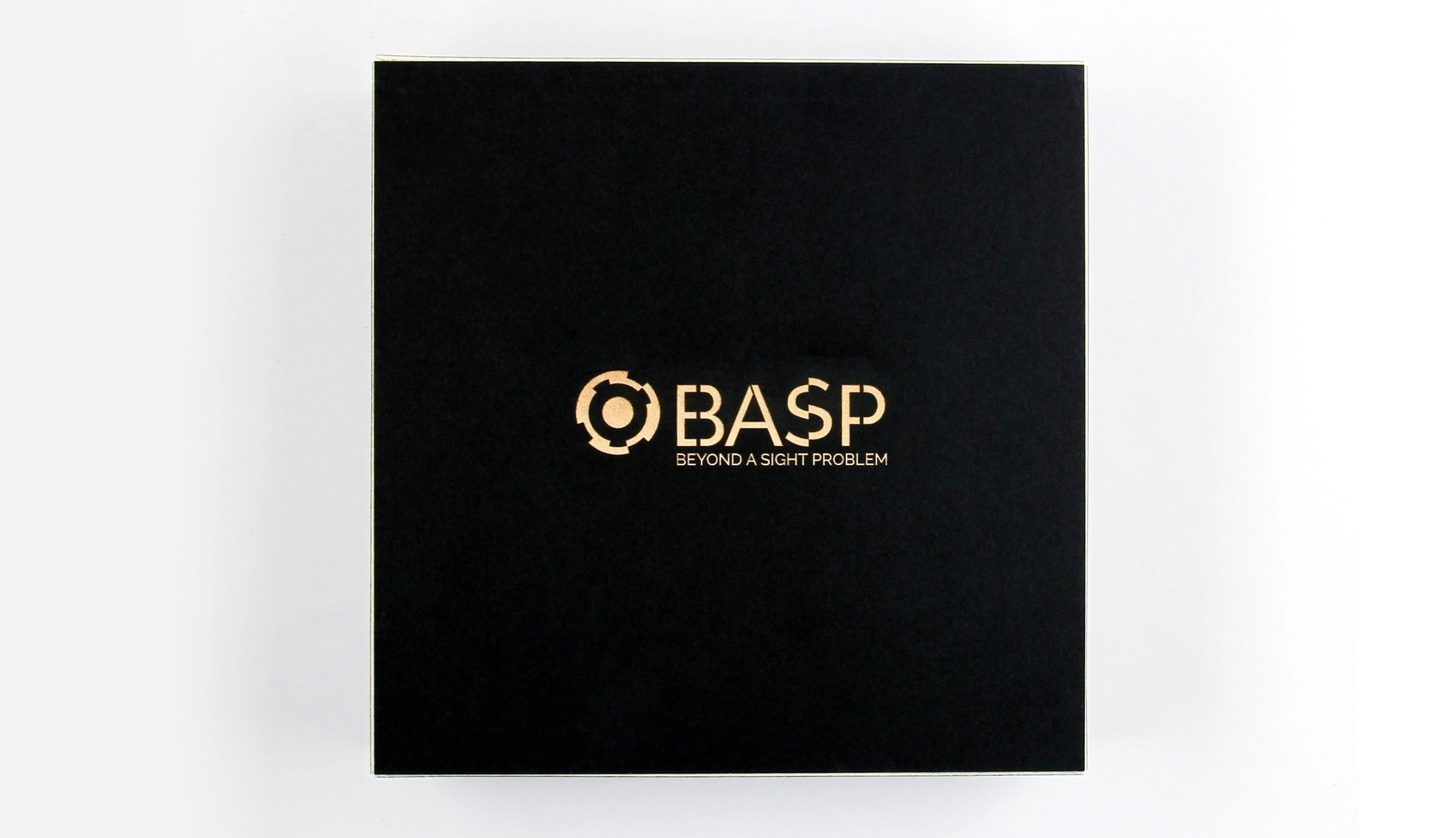 Black board game box with a laser-cut BASP logo etched on the front.