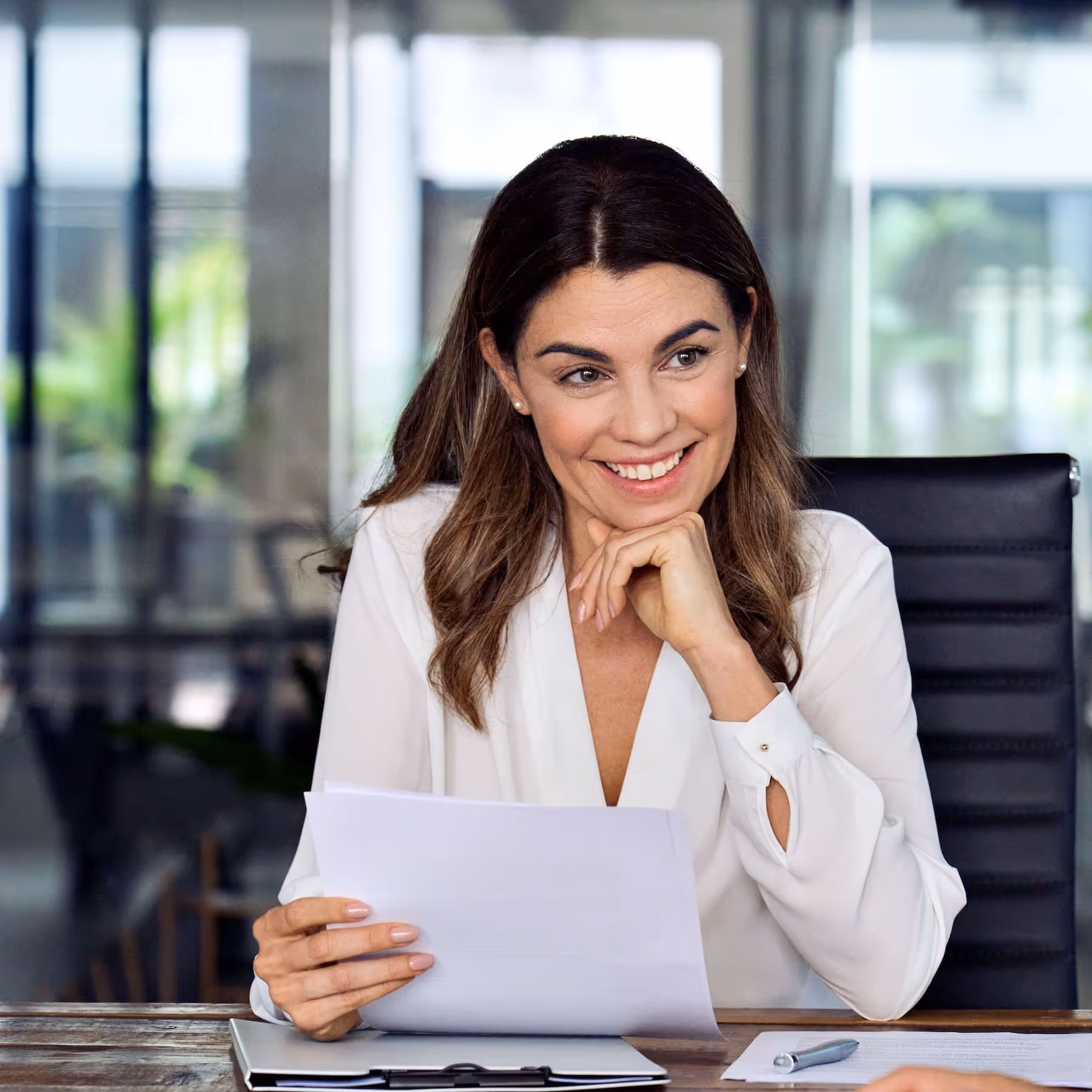 A friendly healthcare sales recruiter reviewing candidate resumes at a desk