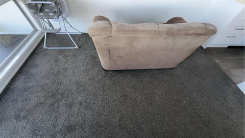Beige armchair, gray carpet, metal chair.