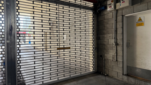 metal security gate, door with warning sign, electrical panels