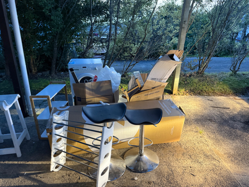 Bar stools, cardboard boxes, trash bag, plastic laundry basket.