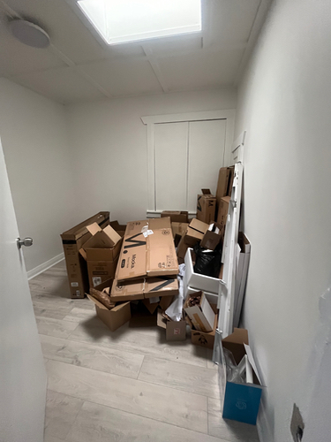 Pile of cardboard boxes, some flattened and some stacked.