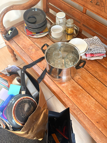 Pots, pans, plates, jars, olive oil, kitchen towels.