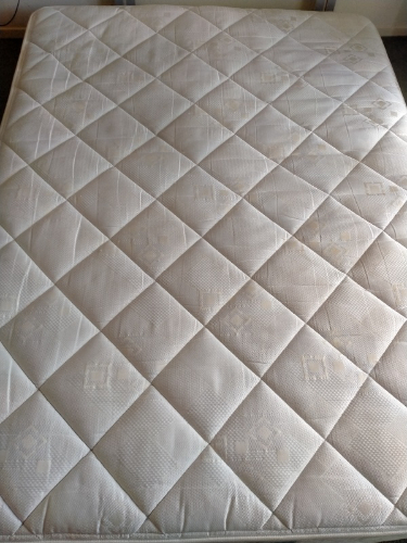 White mattress with diamond-patterned surface.