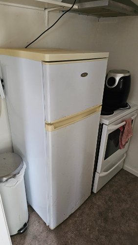 Refrigerator, coffee maker, oven, trash can.