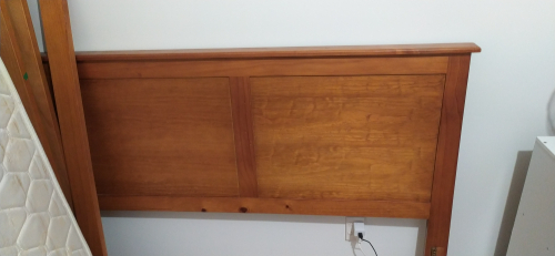 Wooden headboard with a smooth finish and two panel design.