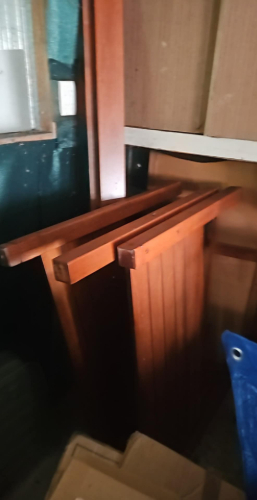 Wooden panels stacked against a wall.