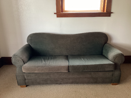 Gray fabric sofa with a rounded back and two seat cushions.