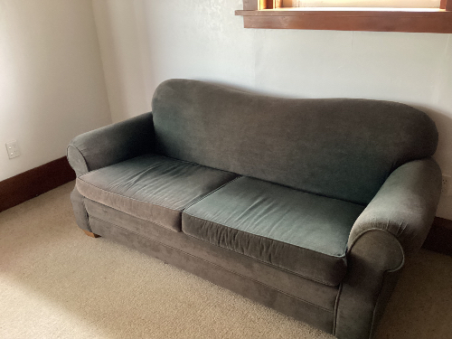 Gray fabric sofa with armrests.