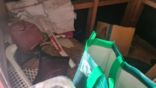 Woven basket, plastic bags, roll of tape, crumpled papers.