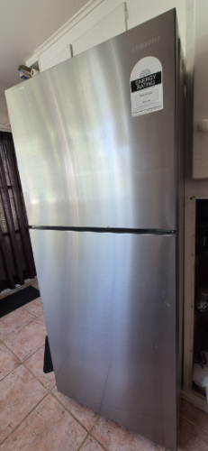 Stainless steel refrigerator with Energy Star sticker.