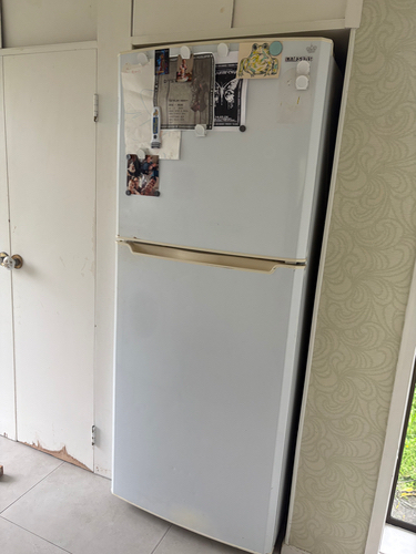 White refrigerator with magnets and notes attached.