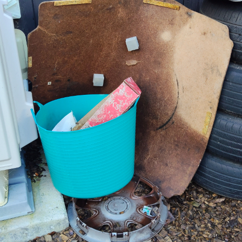 Turquoise bucket, cardboard sheet, red box, hubcap.