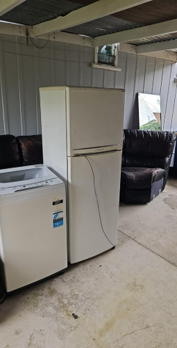 Refrigerator, washing machine, and black leather couch.