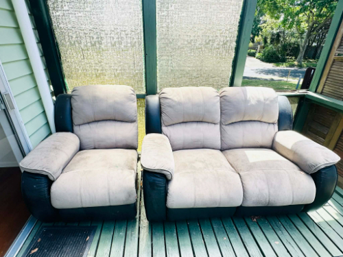 Two beige and black reclining sofas side by side.