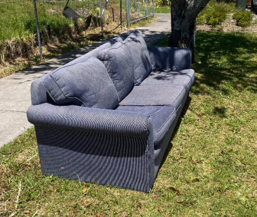 Blue fabric sofa with three seat cushions and two back cushions.