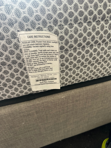 Care instructions tag on a mattress.