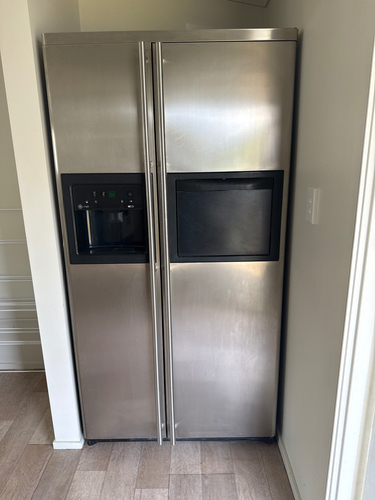 Stainless steel refrigerator with a built-in microwave.