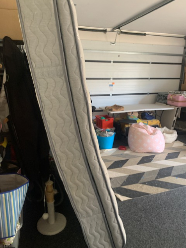 Mattress, storage bins, bean bag chair, carpet.