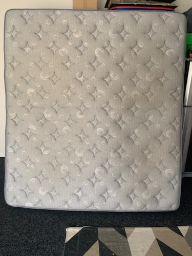 Gray mattress with a patterned surface.