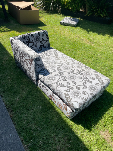 Patterned chaise lounge with floral design.
