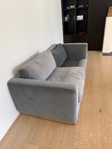 Gray fabric sofa with two cushions.