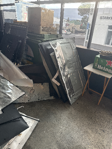 Various stacked panels, boxes, and a small table with Heineken branding.