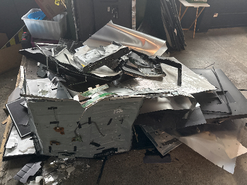 Scrap metal pieces, crumpled aluminum sheets, and disassembled electronic components.