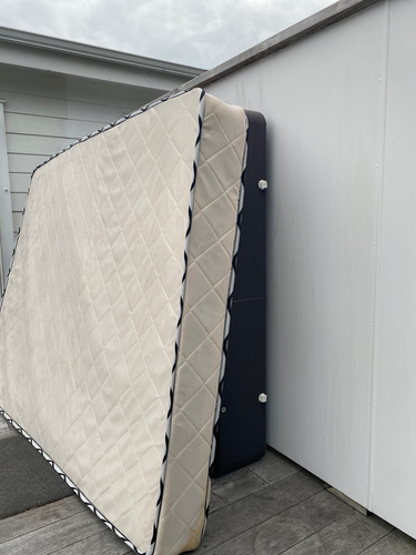 Mattress leaning against a wall.