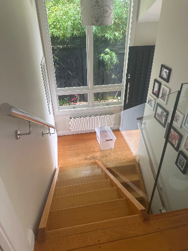 Staircase, handrail, white box, glass panel, photo frames.