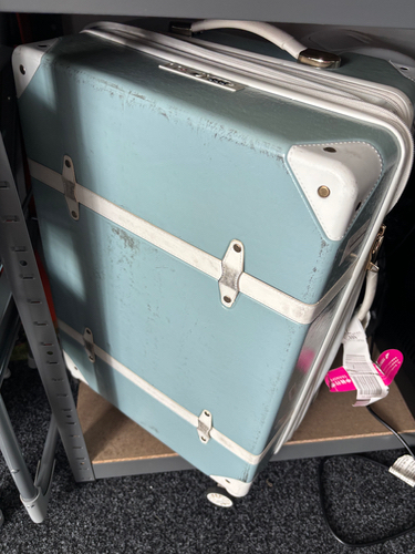 Vintage blue suitcase with white accents.