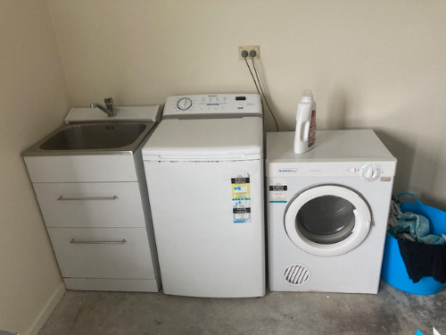 Washing machine, dryer, laundry sink, detergent bottle, blue laundry basket.