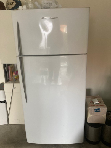 White refrigerator with a silver handle.
