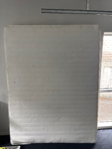 Large white mattress with a floral pattern.