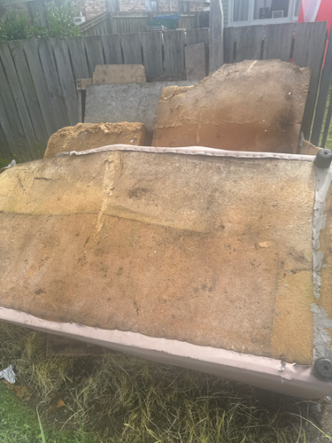 Disassembled pieces of an old mattress with visible padding.