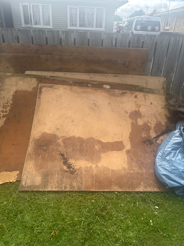 Wooden panels and a blue tarp.